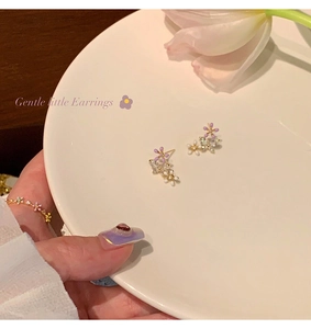 Detail of sweet floral earrings and ring set with purple enamel and crystal accents