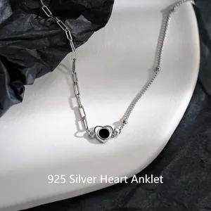 Minimalist 925 silver heart anklet with asymmetric paperclip chain on white ceramic decor