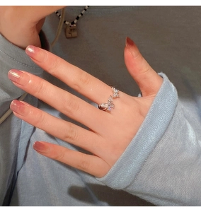 Detail of silver butterfly open ring with sparkling cubic zirconia on model's hand