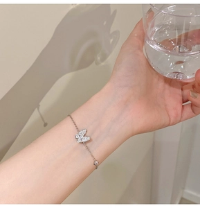 Detailed view of an elegant butterfly bracelet with sparkling pavé stones on a slim chain