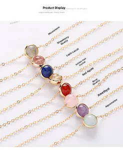 Detail of gold necklace featuring moonstone, strawberry quartz, and lapis lazuli charms