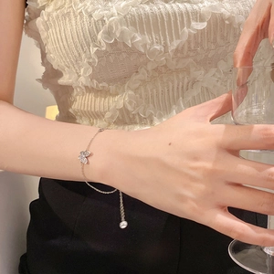 Close-up of a silver butterfly bracelet with shimmering crystals on a woman's wrist