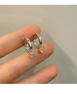 Close-up of silver hoop earrings featuring a delicate pink triangle zircon pendant