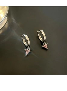 Close-up of silver hoop earrings with sweet pink triangle gemstones on black background