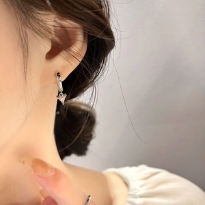 Elegant silver hoop earrings with pink triangle crystal drop displayed on a model