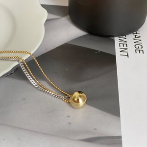 Minimalist double layer gold bead and silver chain necklace with polished sphere pendant