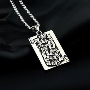 Macro detail of King of Spades poker pendant with skull design on stainless steel chain