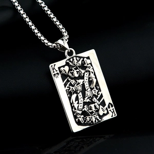 Close-up of gothic stainless steel King of Hearts poker card pendant with skull relief