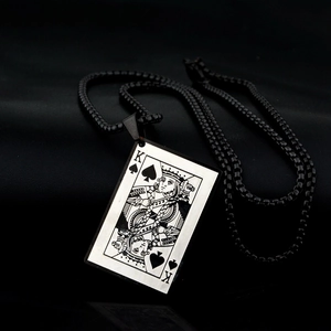 Macro shot of Spade K poker pendant on black box chain with premium leather background