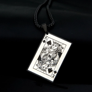 Macro shot of black stainless steel King of Spades playing card pendant with chain