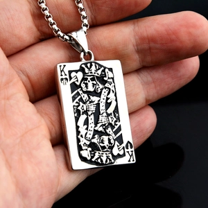 Macro detail of retro punk King of Hearts skull poker pendant with box chain