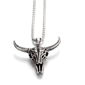 Macro shot of retro silver bull skull pendant with hollow textures and rolo chain link