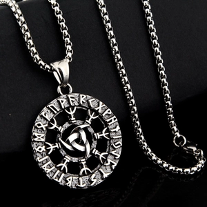 Close-up of vintage stainless steel Viking pendant with Triskelion and Elder Futhark runes