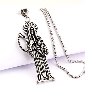 Détail macro du pendentif Santa Muerte sur une chaîne box en acier inoxydable vieilli