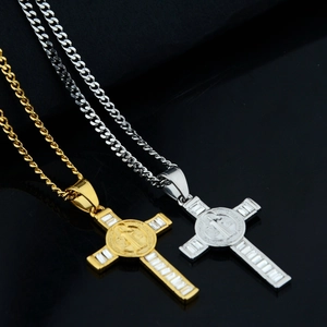 Detailed close-up of gold and silver cross pendants with zircon on black reflection