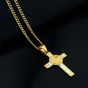 Detail of gold cross pendant with baguette-cut diamonds and St. Benedict medal
