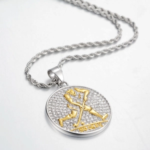 Detail of silver hockey pendant with gold athlete relief and sparkling rhinestones