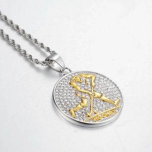 Macro detail of iced-out hockey pendant with gold athlete relief and silver rope chain