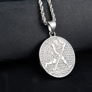 Macro shot of silver polished hockey pendant with cubic zirconia and a rope chain
