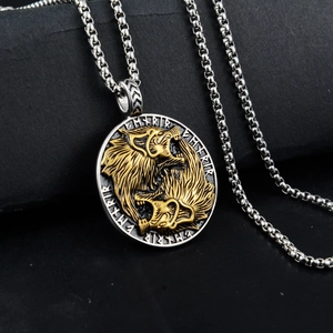 Macro shot of Viking wolf relief pendant with Nordic runes on black leather backdrop
