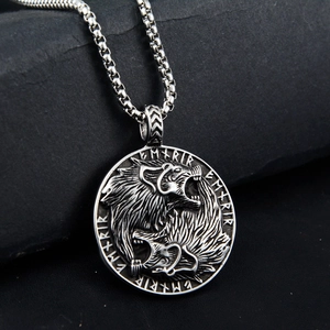 Detail of Viking wolf head pendant with Runic symbols and antique silver finish