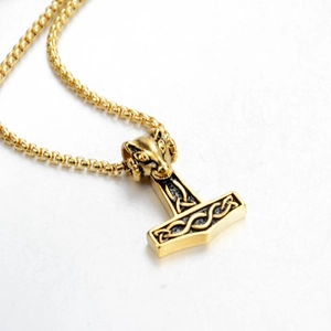 Golden Viking Mjolnir pendant necklace with ram head and intricate Nordic knotwork