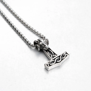 Detailed view of Viking Mjolnir pendant featuring a ram head and Celtic knot patterns