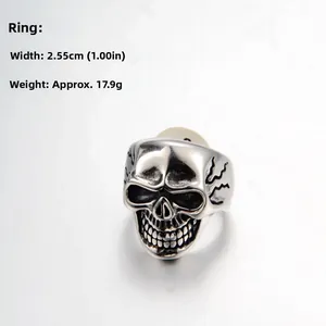Macro detail of retro silver skull ring showing weathered texture and punk style carvings