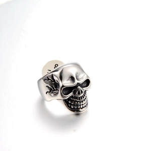 Macro detail of gothic skull ring in titanium steel with retro flame engravings