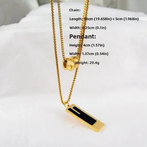 Detailed view of golden double-layered box chain necklace with square enamel pendant