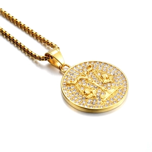 Détail du collier zodiaque doré avec relief de croix et cristaux scintillants