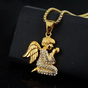 Hip hop style gold angel pendant necklace with white rhinestones on a black background