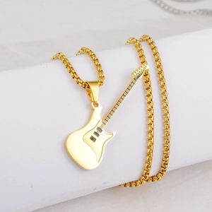 Macro view of gold-plated guitar pendant necklace with round box chain on display
