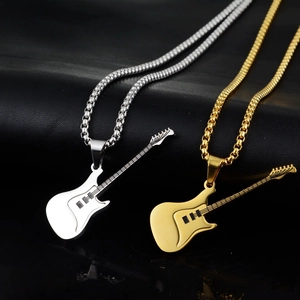 Detail of guitar pendant necklaces in silver and gold colors with polished box chain