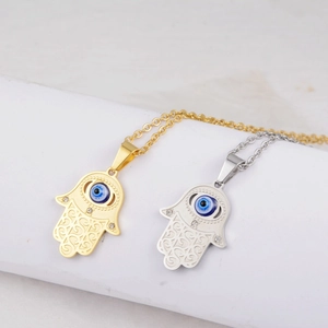 Hamsa Hand Evil Eye pendant necklace in gold and silver finish with crystal accents