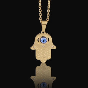 Gold Hamsa Hand necklace with blue evil eye pendant and intricate geometric engraving