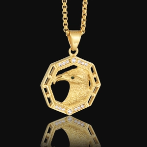 Vue détaillée du pendentif aigle doré avec œil en pierre verte et oxydes de zirconium