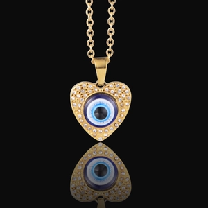 Hip hop heart pendant necklace with evil eye design and pavé crystals on black background