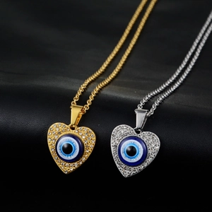 Hip hop heart evil eye pendant necklace in gold and silver finish with sparkling rhinestones