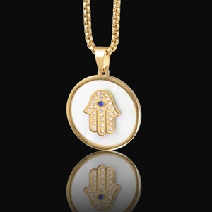 Golden Hamsa necklace with white mother of pearl inlay and blue center stone pendant