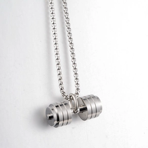 Close-up of a silver dumbbell pendant on a circular link chain with mirror polish finish