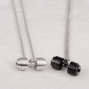Detail of silver and black dumbbell pendant necklaces with metallic bead chains