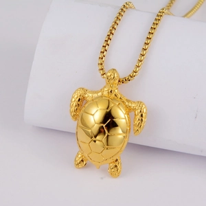 Detailed close-up of golden turtle pendant with intricate shell texture on box chain