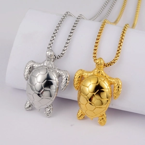 Detailed close-up of realistic gold and silver turtle pendants with textured shells