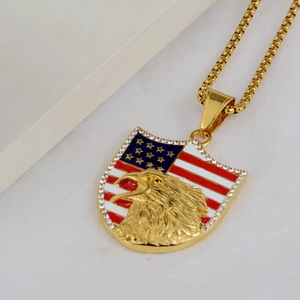 Macro shot of gold-plated eagle shield pendant with US flag enamel and small rhinestones