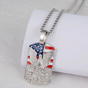 Detail of an eagle dog tag necklace featuring a US flag pattern and crystal inlay