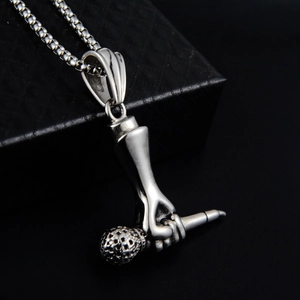 Gros plan du pendentif microphone hip hop argenté avec strass sur chaîne à billes