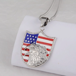 Detail of shield pendant featuring eagle head and American flag pattern with rhinestones