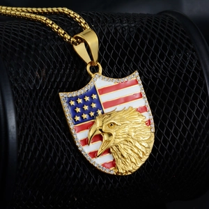 Detail of shield pendant with eagle emblem and American flag enamel on a gold box chain
