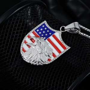 Detail of shield pendant with American flag enamel, eagle relief and white crystals